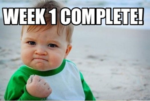 A toddler with a determined expression, raising a clenched fist, celebrating success with the text 'WEEK 1 COMPLETE!' in bold above them, set against a beach background.